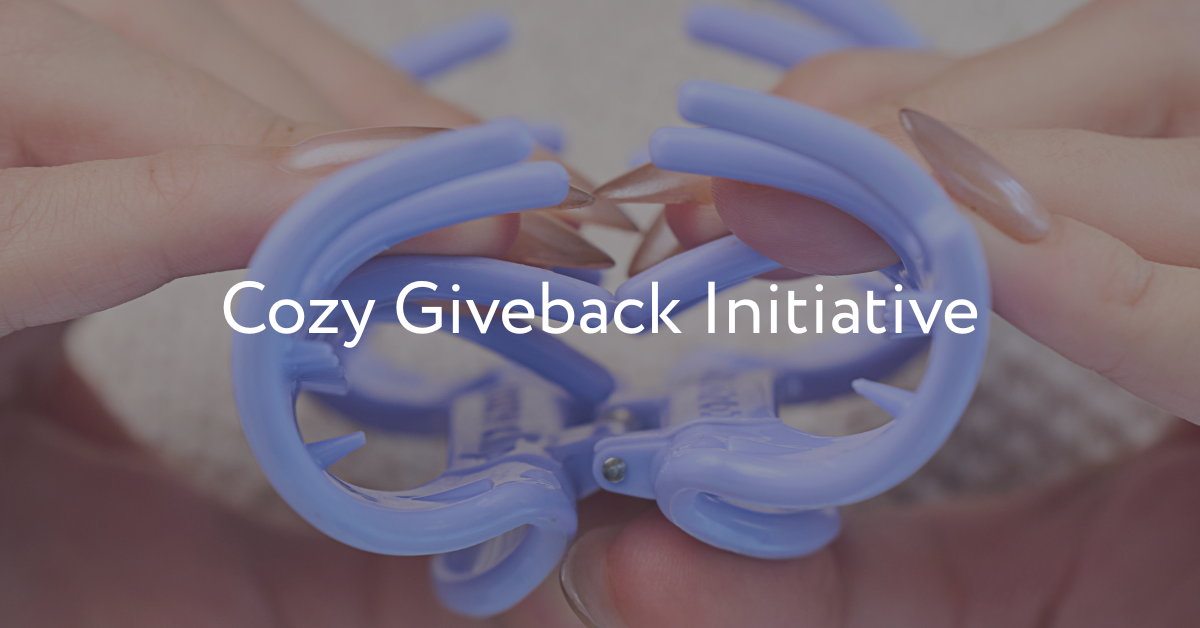 Cozy Giveback Initiative — close-up of hands pinching open a lavender Cozy Clip hair clip