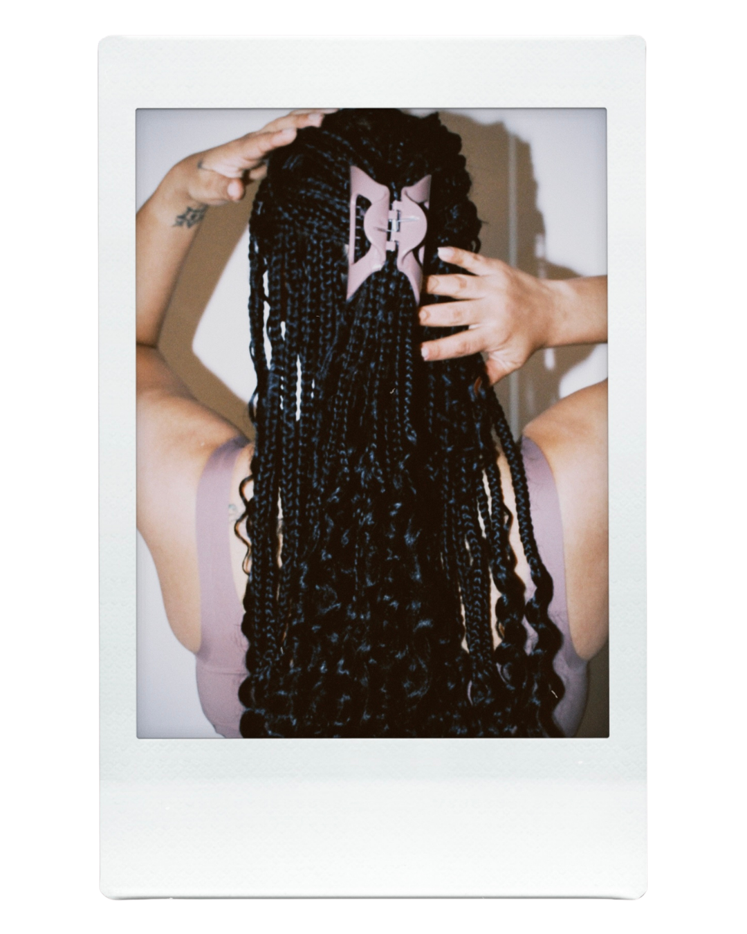 Back view of a woman with braids wearing a cove cozy clip